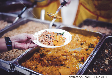 Volunteers are sharing food to needy hungry 66230118