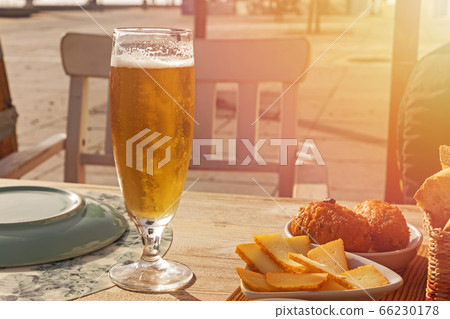 Mug with cold beer on thetable of outside terrace Mug with cold beer on thetable of outside terrace 66230178