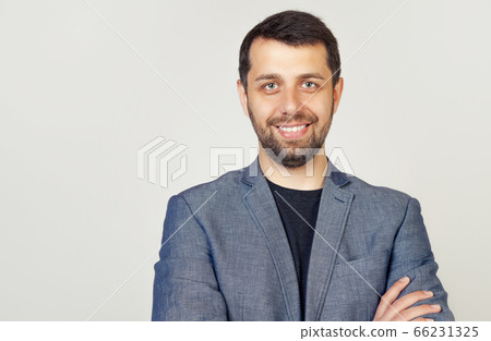 Portrait of a young male entrepreneur smiling broadly with a self-confident expression 66231325