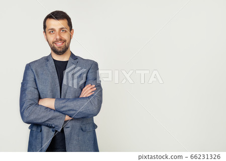 Portrait of a young male entrepreneur smiling broadly with a self-confident expression 66231326