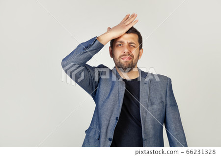 Male businessman resting his hand on his forehead remembering something important 66231328