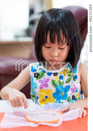Asian girl home schooling sewing 66231364
