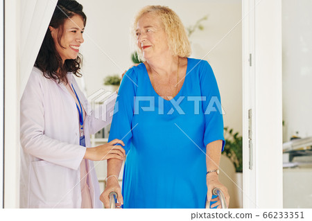 Medical nurse helping senior patient 66233351