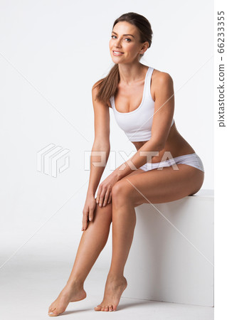 Woman in underwear touch legs Woman in underwear touch legs 66233355