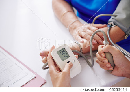 Measuring blood pressure of elderly woman Measuring blood pressure of elderly woman 66233414