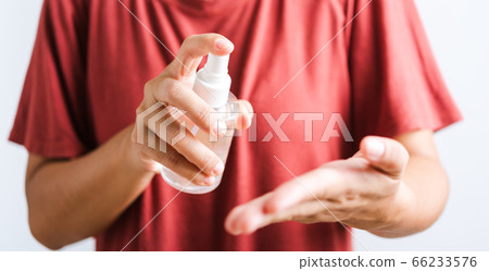 woman applying spray pump dispenser sanitizer woman applying spray pump dispenser sanitizer 66233576