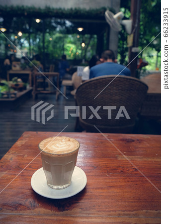 Cup of coffee on table in cafe - vintage style Cup of coffee on table in cafe - vintage style 66233915