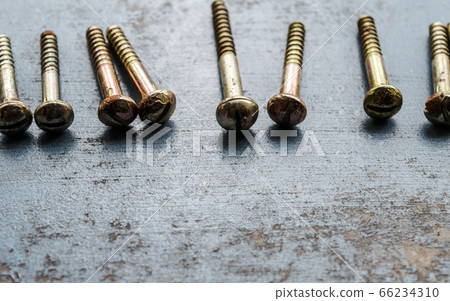 Screw on rusty metallic surface. Close Up. Screw on rusty metallic surface. Close Up. 66234310