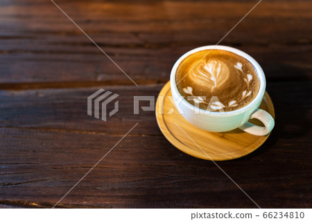 Latte art coffee cup on wooden table 66234810