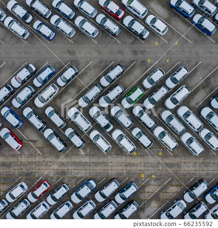 New car lined up aerial view. Port of import and export business logistic to dealership for sale. New car lined up aerial view. Port of import and export business logistic to dealership for sale. 66235592