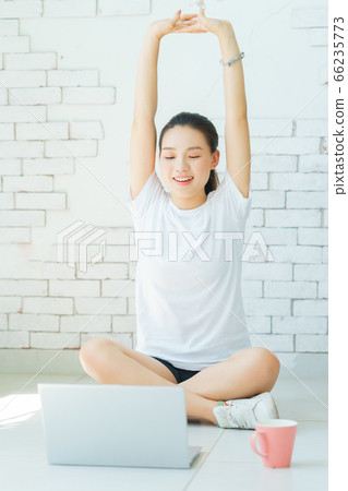 A beautiful woman doing exercise at home A beautiful woman doing exercise at home 66235773