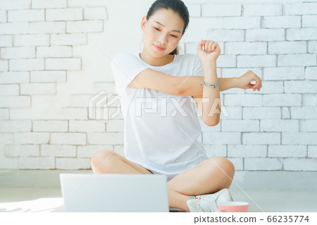 A beautiful woman doing exercise at home A beautiful woman doing exercise at home 66235774