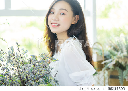 A Beautiful woman in flowers shop A Beautiful woman in flowers shop 66235803