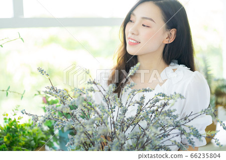 A Beautiful woman in flowers shop 66235804