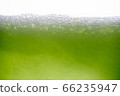 Background of close-up soda bubbles mixed with lemon juice or green juice on white background. 66235947
