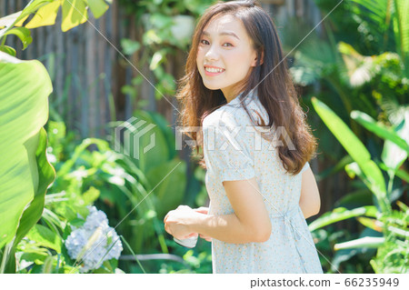 Beautiful woman in the garden 66235949