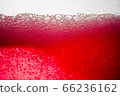 Background of close-up soda bubbles mixed with red fruit juice on white background. 66236162
