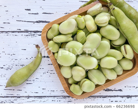 closeup of raw broad bean seeds on wooden table 66236698