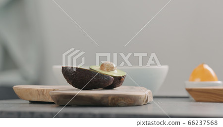 open ripe avocado on kitchen countertop side view open ripe avocado on kitchen countertop side view 66237568