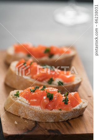 Bruschettas with salmon and cream cheese on olive wood board Bruschettas with salmon and cream cheese on olive wood board 66238031