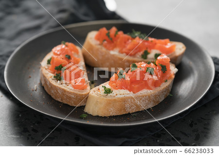 Bruschettas with salmon and cream cheese on black plate closeup 66238033
