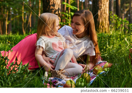 mother with little daughter have fun talking on a mother with little daughter have fun talking on a 66239031