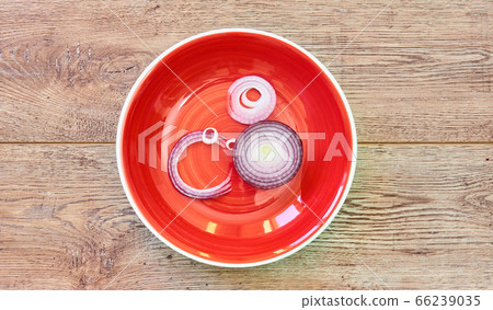 bulb of sweet purple onion sliced in rings on a 66239035