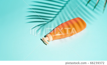 Orange container for cosmetics without label lies 66239372