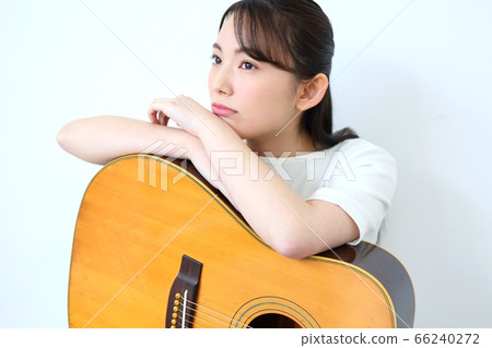 Woman with acoustic guitar Woman with acoustic guitar 66240272