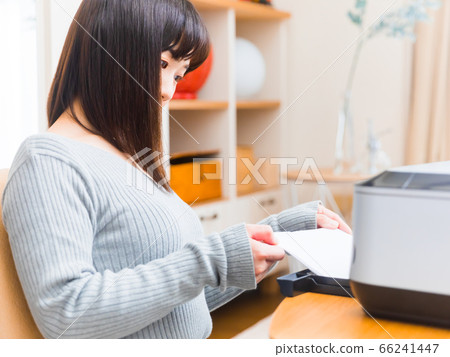 Woman setting paper in printer Copy space 4:3 Woman setting paper in printer Copy space 4:3 66241447
