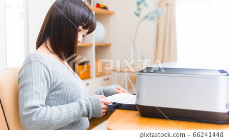 Woman setting paper in printer Copy space 16:9 Woman setting paper in printer Copy space 16:9 66241448