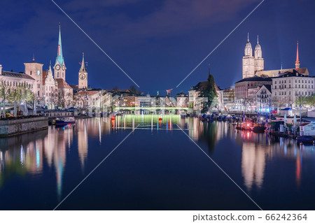 Panoramic view of historic Zurich city center with famous Fraumunster Church and river Limmat at Lake Zurich , in twilight, Canton of Zurich, Switzerland 66242364