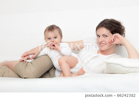 Mother playing with baby Mother playing with baby 66242382