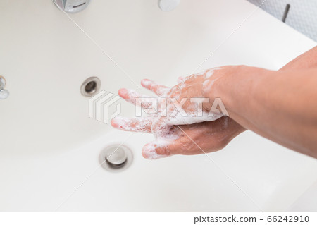 Senior man washing between fingers of hand 66242910