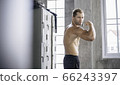 Caucasian male showing biceps muscle at gym fitness. muscular man workout for better health 66243397