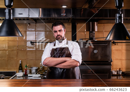 Serious chef at restaurant kitchen Serious chef at restaurant kitchen 66243623