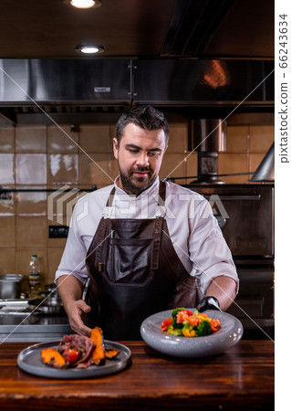 Chef serving dishes Chef serving dishes 66243634