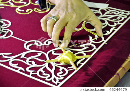 Traditional Mancala boardgame or congkak in Malay with glass pieces on wooden table.  66244679
