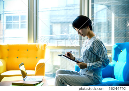 Business woman answering the questionnaire in the office Business woman answering the questionnaire in the office 66244792