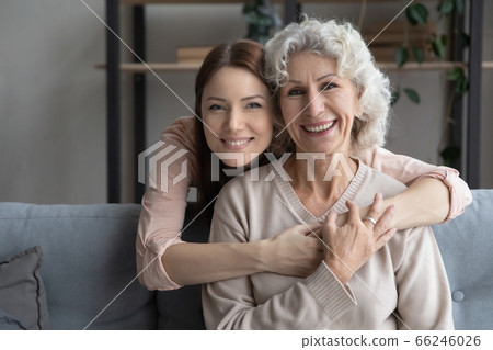 Portrait of loving adult daughter hug mature mom 66246026