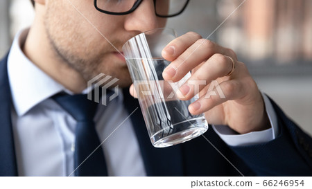 Close up of male employee drink clean water Close up of male employee drink clean water 66246954