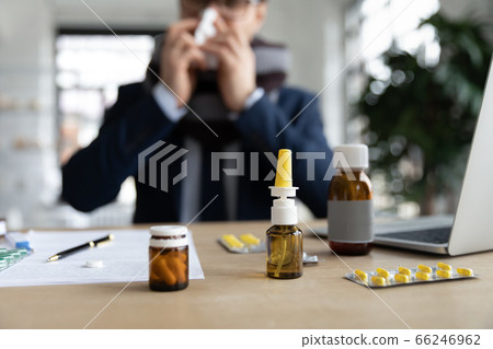 Close up of sick worker take medications at workplace 66246962