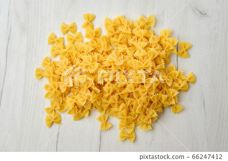 Top view of raw farfalle pasta with spice and Top view of raw farfalle pasta with spice and 66247412