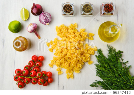 Top view of raw farfalle pasta with spice and Top view of raw farfalle pasta with spice and 66247413