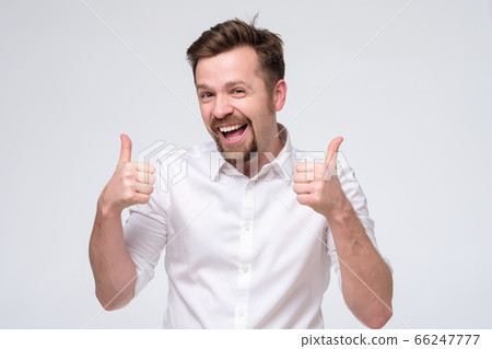 Happy caucasian man with thumbs up gesture 66247777