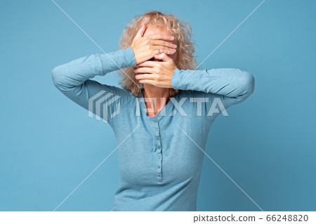 Senior caucasian woman covering her face with palms. 66248820