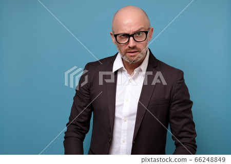 mature man looking with mistrust does not believe in news or government. 66248849