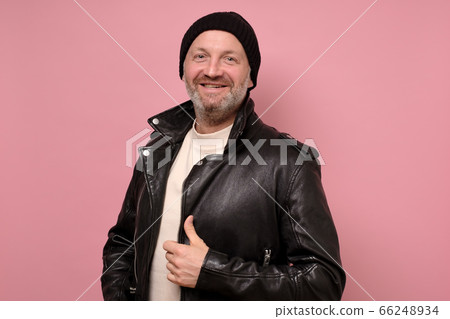 Confident handsome mature man in leather jacket smiling looking at camera Confident handsome mature man in leather jacket smiling looking at camera 66248934