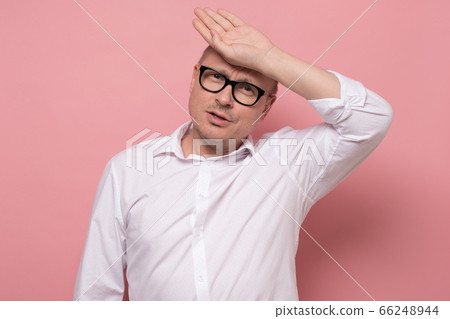 mature man in white shirt is worried and tired during hot summer weather. mature man in white shirt is worried and tired during hot summer weather. 66248944