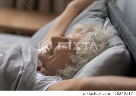 Happy mature woman awaken from good sleep at home 66249117